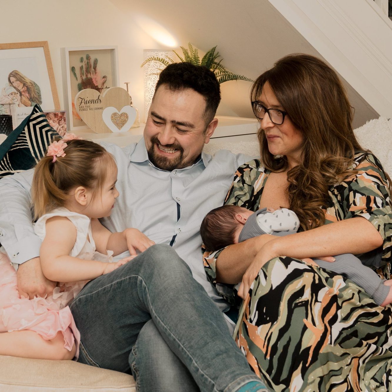 Parents admiring their newborn baby during an at home newborn photography session in County Antrim.